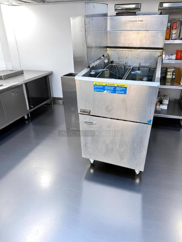 Pitco commercial deep fryer, stainless steel, dual-basket, used condition, visible caution labels, suitable for restaurant use.