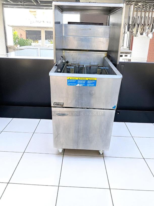 Pitco commercial deep fryer in stainless steel, dual baskets, caution labels visible. Good condition, ideal for restaurant use.