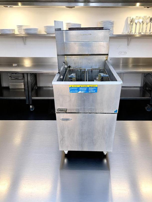 Pitco commercial deep fryer in stainless steel, dual basket, front control panel, warning labels, clean condition.
