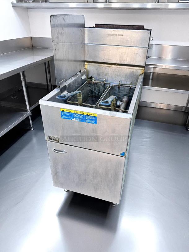Pitco commercial deep fryer in stainless steel, dual baskets, used condition, visible caution label, ideal for restaurant use.