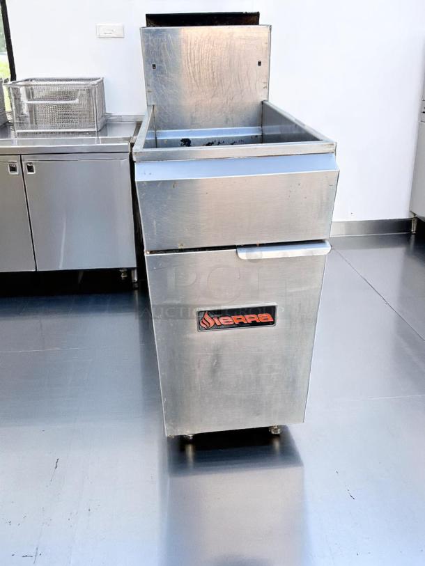 Sierra commercial deep fryer, stainless steel, used condition, logo on front, open lid, suitable for professional kitchens.