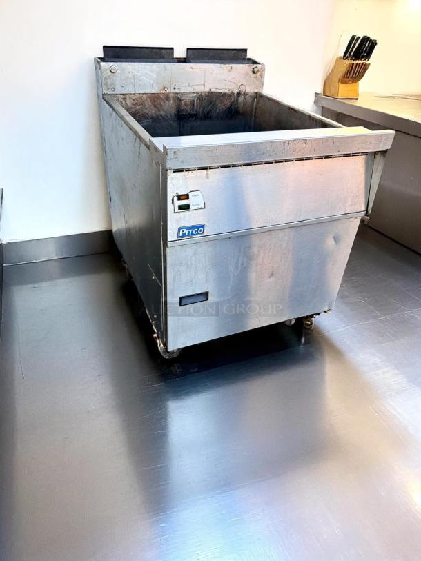 Pitco commercial deep fryer, stainless steel, no baskets, visible wear, control panel intact, ideal for restaurant use.