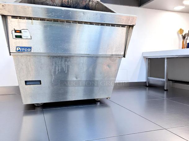 Pitco commercial fryer in stainless steel with visible wear. Features power and heating indicators. Ideal for large kitchens.