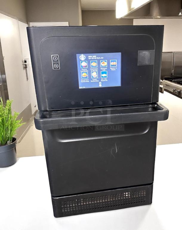 Commercial kitchen food oven with digital control panel, menu display, matte black finish, in good condition.