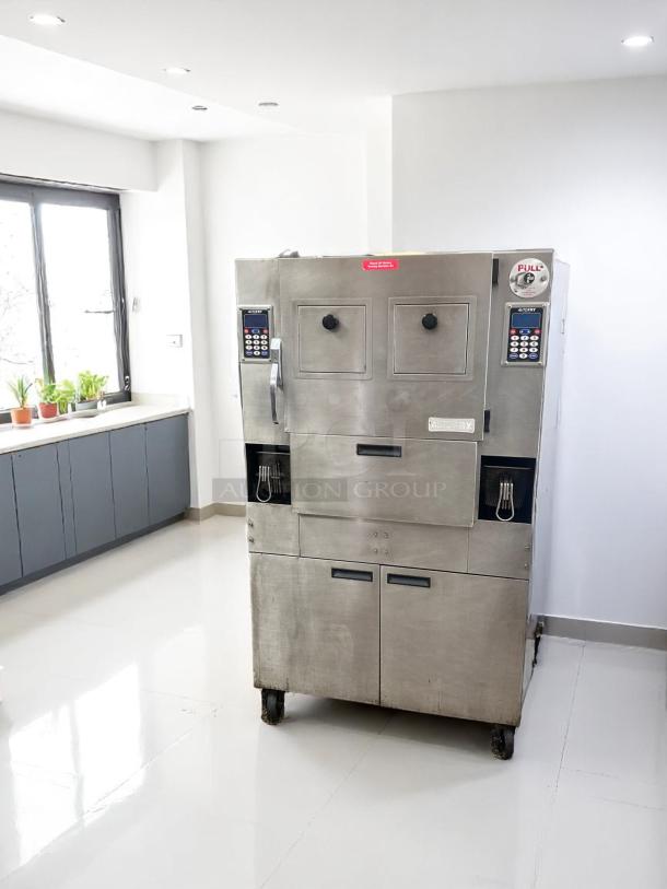 Commercial stainless steel oven with dual control panels, timer, and "PULL" label, on wheels. Used condition.