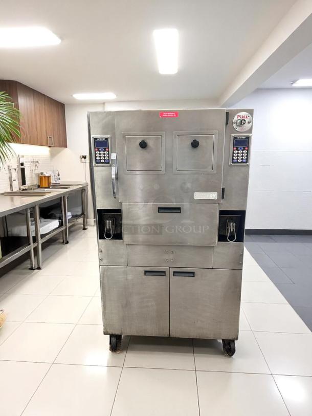 Commercial AutoFry deep fryer, stainless steel, dual compartments, digital controls, good condition, on wheels.