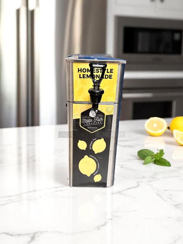 Stainless steel lemonade dispenser with spigot, featuring "Homestyle Lemonade" and "State Fair" labels, in excellent condition.