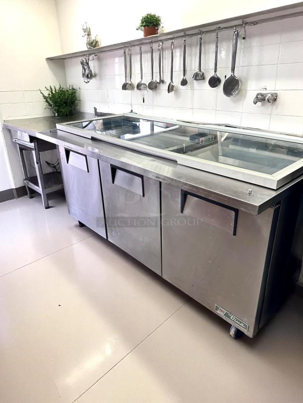 Stainless steel commercial refrigerator with three doors and glass display top, in good condition, labeled "VESTFROST."
