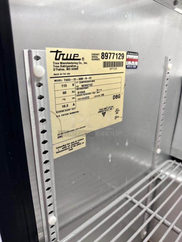 Industrial refrigerator label, Model TSSU-72-30M-B-ST by True Manufacturing. Serial 8977129, 115V, R134A refrigerant. Made in the USA.