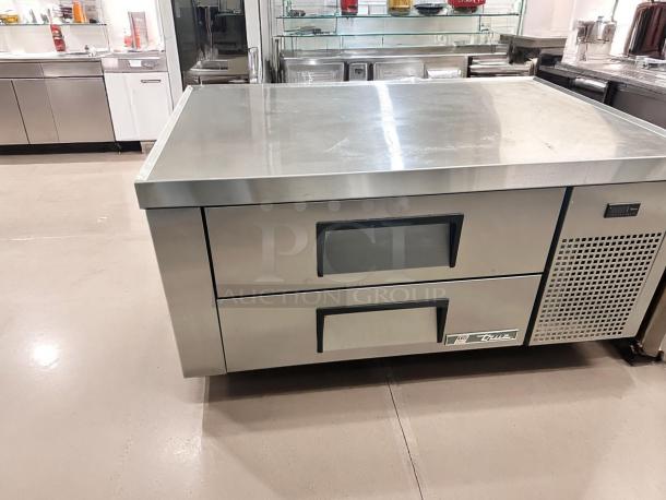 Commercial stainless steel refrigerated prep table with two drawers, sturdy surface, brand logo "True", excellent condition.