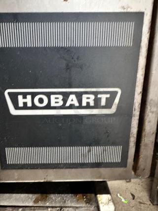 Hobart equipment panel with logo, likely part of a commercial kitchen appliance. Appears in used condition with visible wear.