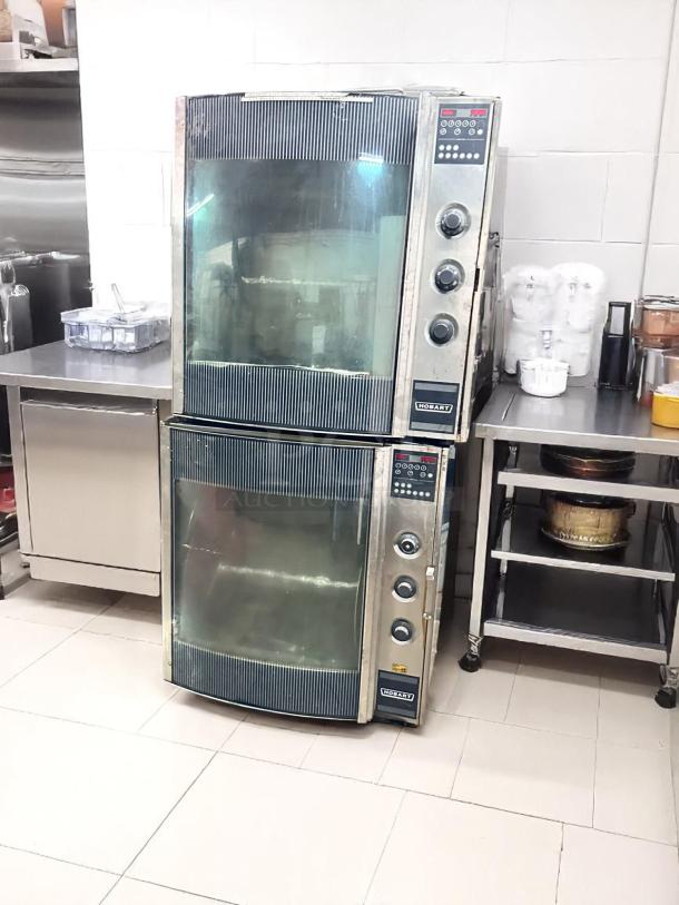 Commercial double-stack Hobart convection ovens, stainless steel, digital controls, visible glass doors, good condition.