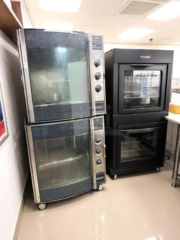 Two Hobart commercial ovens, stainless steel finish, with glass doors and control knobs, appear in good condition.
