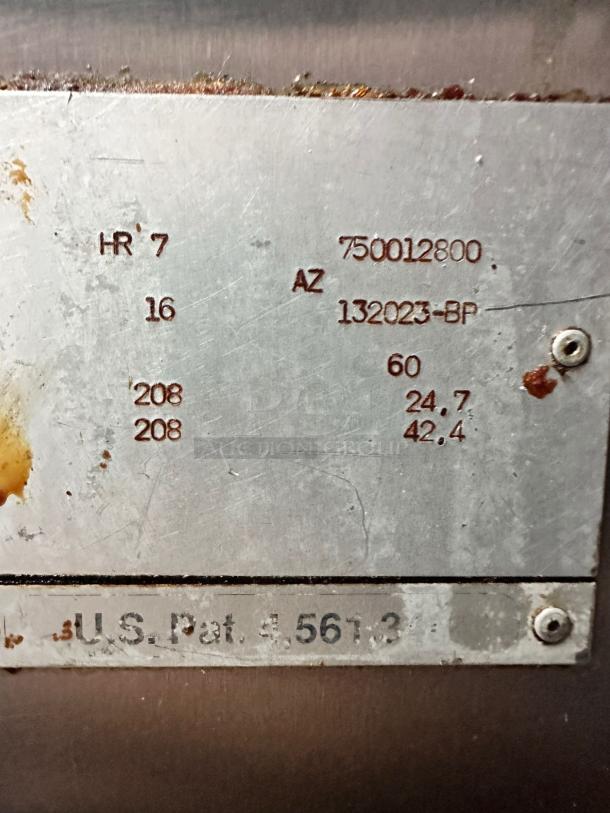 Metal plate with engraved numbers and letters, including "750012800," "132023-BP," and "U.S. Pat. 4,561,3??," indicates technical specifications.