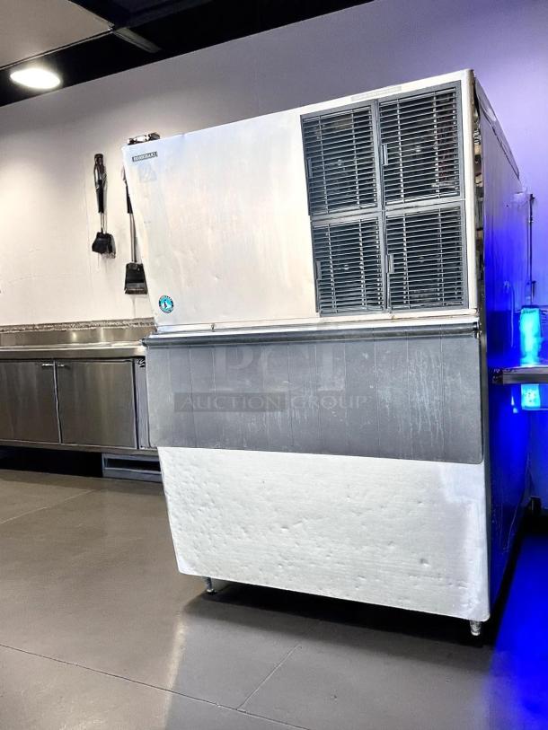 Stainless steel industrial ice machine; robust build, visible vents, used condition, possible brand label on top left.