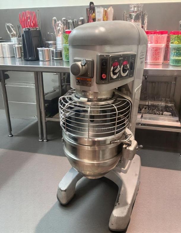 Hobart commercial mixer with stainless steel bowl and safety guard, in good condition, control panel visible.