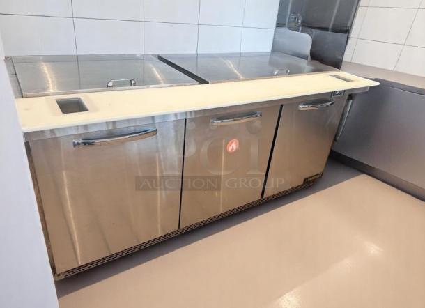 Stainless steel commercial refrigerator with prep surface, three doors, gentle use; red flame label on front.