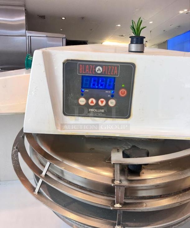 Blaze Pizza Proluxe dough press with digital controls, in used condition. Displays temperature setting of 860.