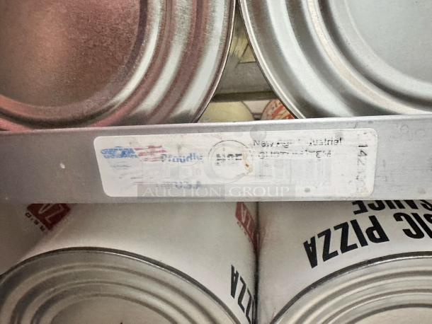 Aluminum shelf with cans and label indicating "New Age Industrial," showing signs of wear.