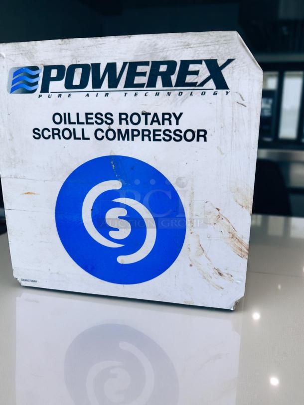 Powerex Oilless Rotary Scroll Compressor, box with blue logo, showing wear and smudges. Model DK0957036M.