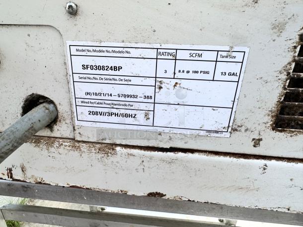 Metal machine with visible label indicating model SF030824BP, 13-gallon tank, 8.8 SCFM at 100 PSIG, 208V/3PH/60Hz, worn condition.