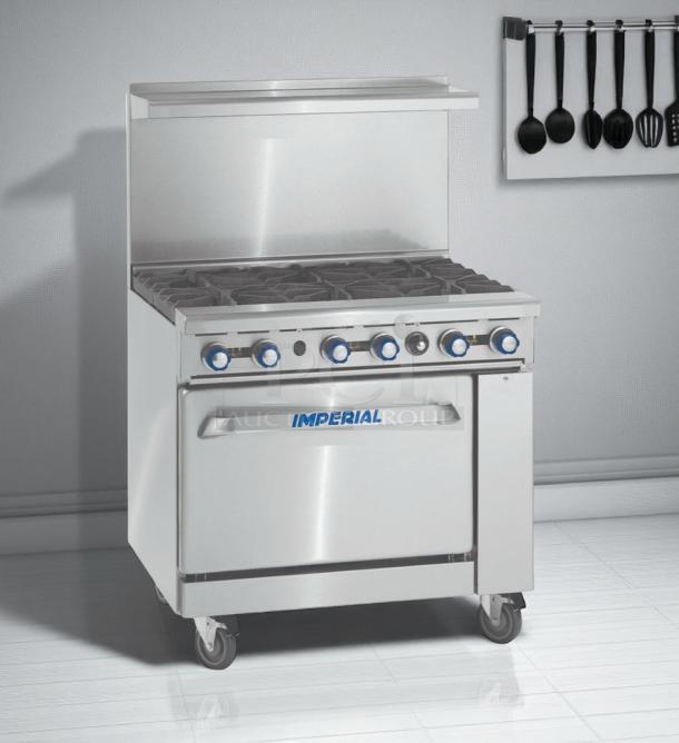 Stainless steel Imperial commercial gas range, six burners, oven, control knobs, on casters, brand logo visible.