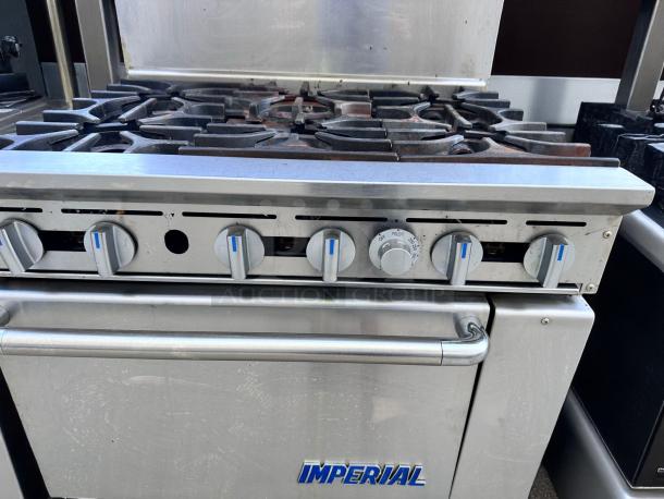Commercial stainless steel gas stove by Imperial, featuring six burners and control knobs. Good condition, ideal for restaurants.