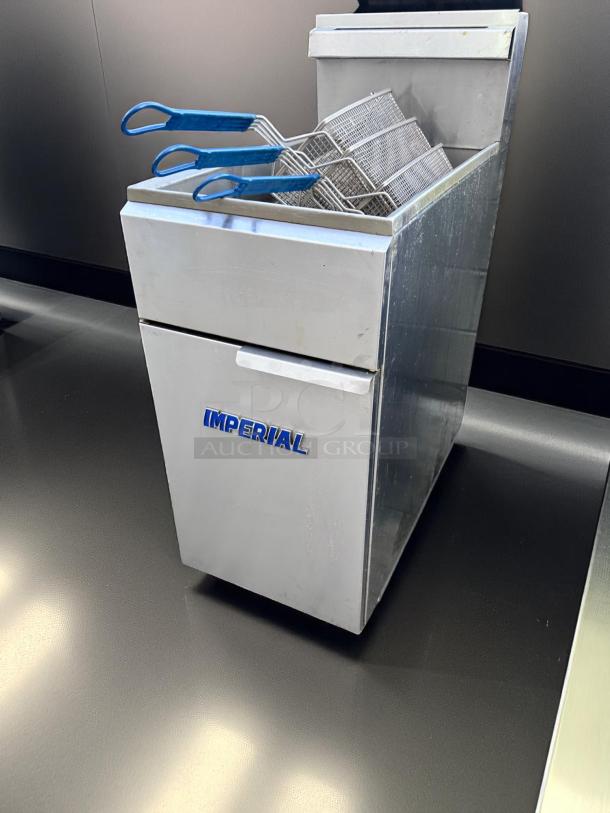 Stainless steel Imperial deep fryer, three baskets with blue handles, in good condition, suitable for commercial use.