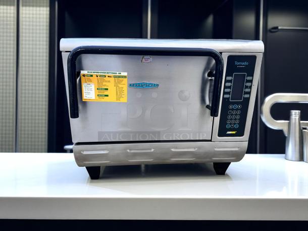 TurboChef Tornado oven, stainless steel, digital controls, visible settings label. Auction tag, good condition.