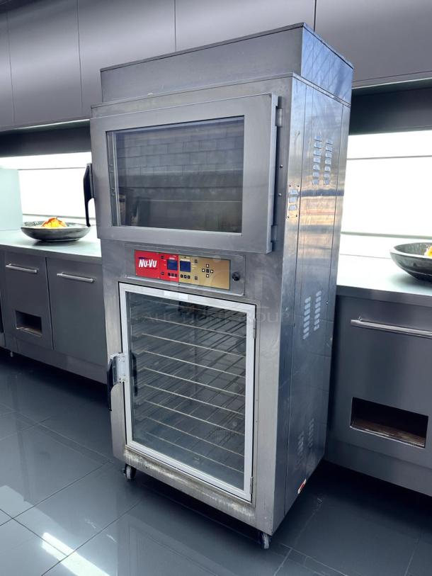 Nu-Vu commercial oven, stainless steel, two sections with glass doors, control panel, casters, in good condition.