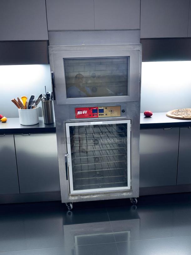 Stainless steel NU-VU commercial oven, double-door with digital controls, on casters. Visible wear on lower door.