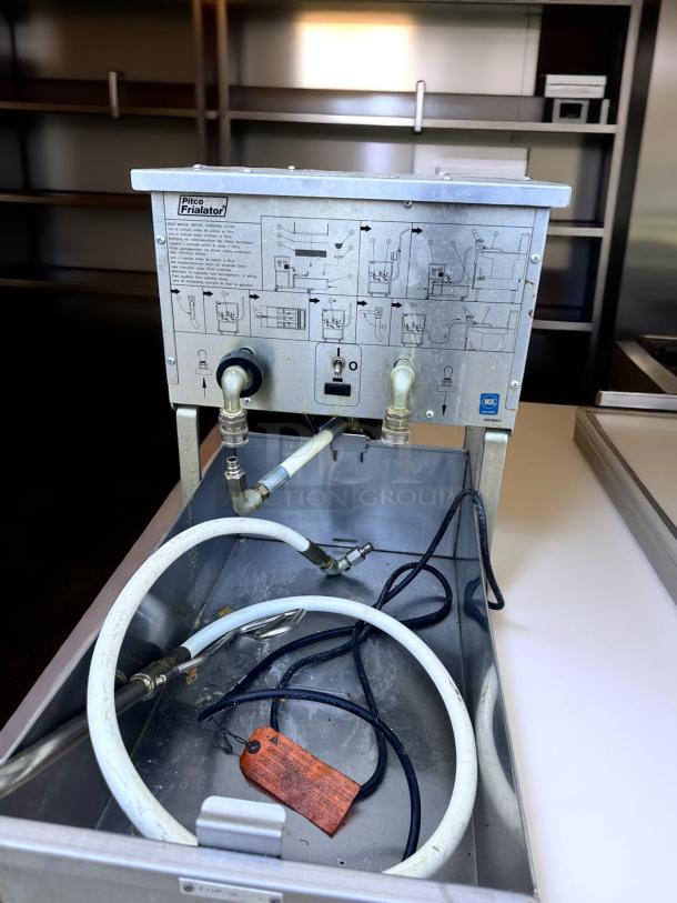 Pitco Frialator with connectors and hoses; used condition, detailed instructions and NSF certification visible on the panel.