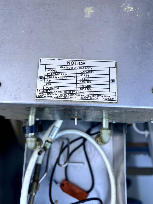 Commercial fryer with a maximum oil capacity notice, listing models P14, P18, P24, P34, and P90 with respective capacities.