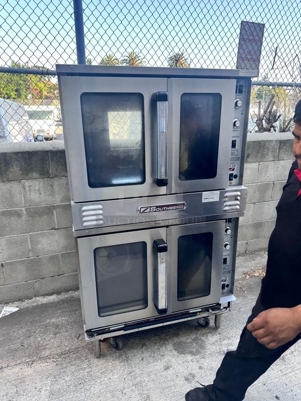 Southbend double-deck commercial convection oven on wheels, stainless steel, dual glass doors, control panel visible, used condition.