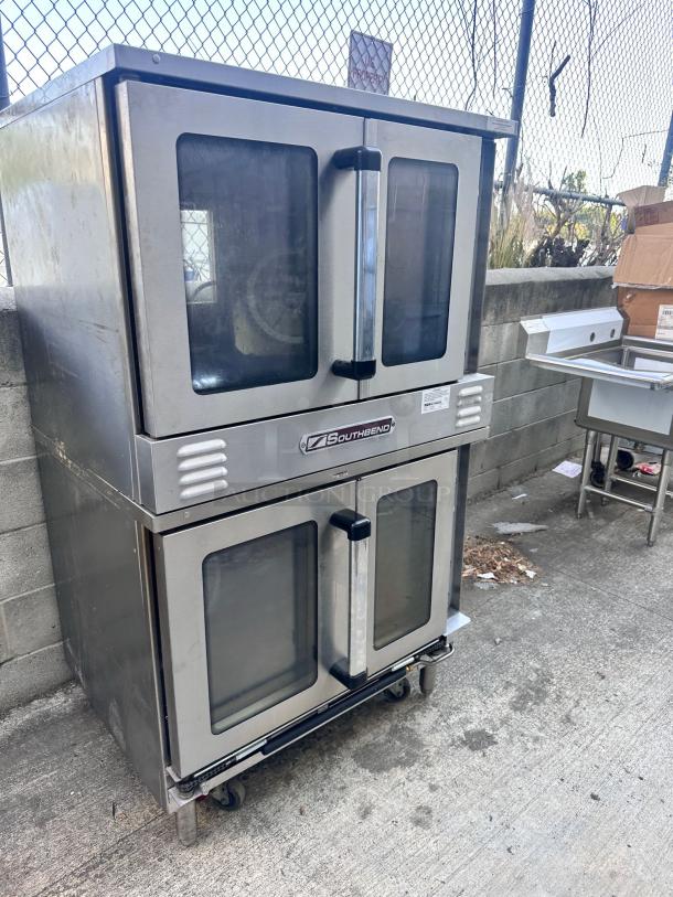 Southbend double convection oven, stainless steel, glass doors, on casters, used condition. Model tag visible.