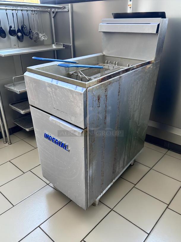 Imperial commercial deep fryer with stainless steel exterior, slight rust, visible control panel, and fryer baskets.