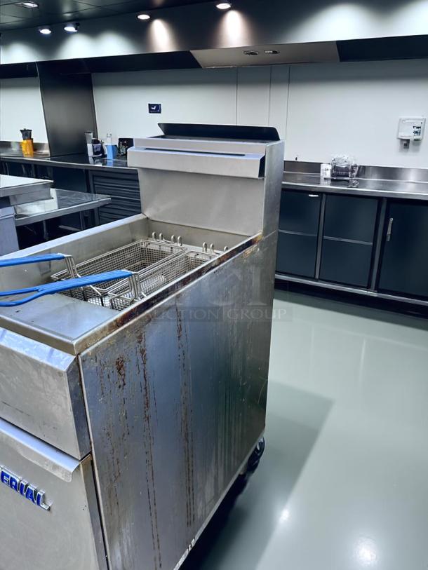 Commercial deep fryer, stainless steel, signs of wear and oil stains, Imperial brand visible, suitable for high-volume kitchens.