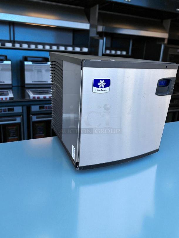 Manitowoc ice maker, stainless steel, compact design, logo visible, excellent condition, suitable for commercial use.