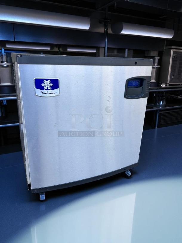 Manitowoc commercial ice machine with stainless steel finish, good condition, logo visible.