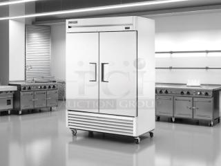 Commercial double-door stainless steel refrigerator on wheels, new condition, model tag visible at top.