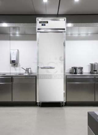 Commercial stainless steel refrigerator in a modern kitchen, featuring digital controls. Appears in excellent condition.