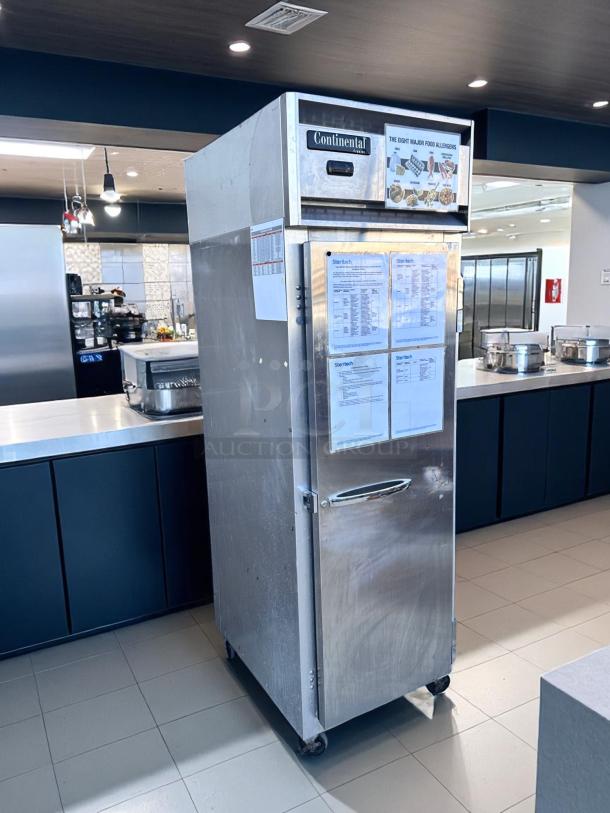 Continental commercial food warmer, stainless steel, single door, on casters, visible allergen and instruction labels, used condition.