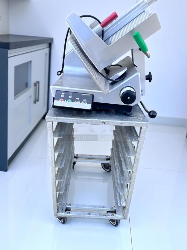 Bizerba slicer on a metal rack cart, features control panel for settings, red and green handles, in good condition.