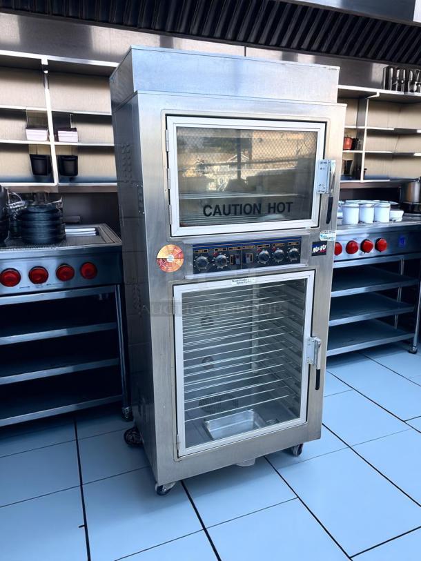 Commercial stainless steel food warmer with two glass doors, digital controls, and visible "Caution Hot" label, in excellent condition.
