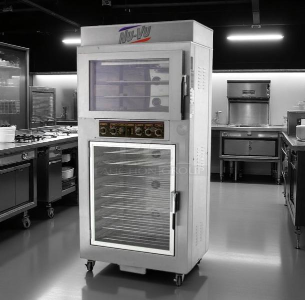 Nu-Vu commercial oven warmer with dual doors, control panel, and visible interior racks in stainless steel, on casters.