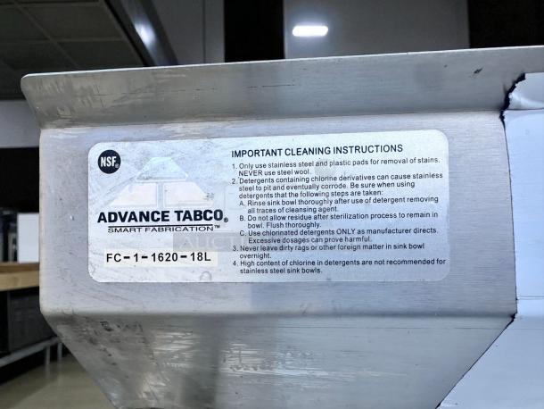 Stainless steel sink by Advance Tabco, model FC-1-1620-18L, with cleaning instructions label. Appears in used condition.