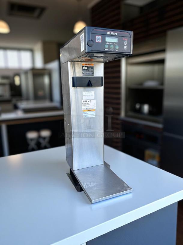 Bunn digital coffee brewer, stainless steel, countertop model, digital display, good condition, with operational labels.