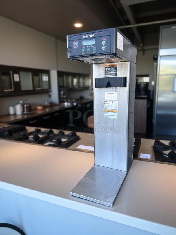 Bunn coffee brewing machine in stainless steel, Model Dual Brew Control. Features a digital display, warning labels, and clean condition.