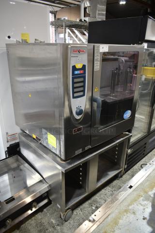 Rational SCC102G Stainless Steel Commercial Natural Gas Powered Combi Convection Oven on Equipment Stand w/ Pan Rack on Commercial Casters.