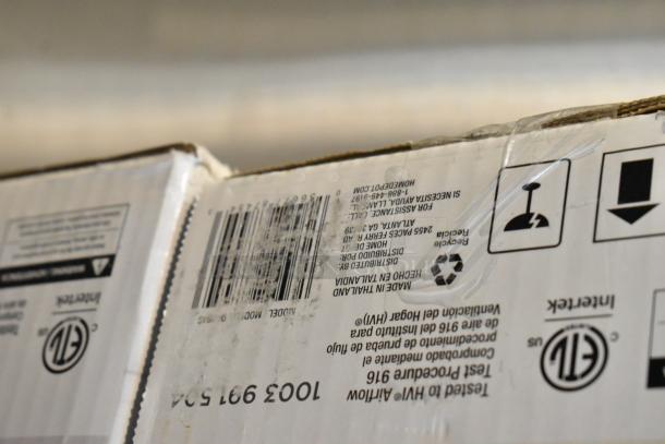 Cardboard box with barcode, recycling symbol, and handling icons. Text indicates it's made in Thailand. Slight wear visible.